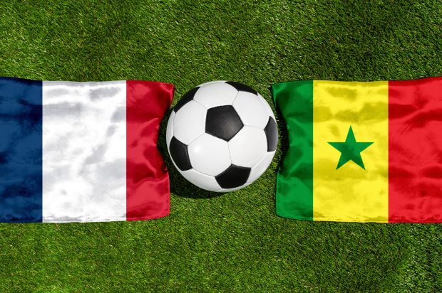 PHOTOMONTAGE, FIFA Football World Cup 2026: National Flags Of Frankreich And Senegal With A Football On Grass. Symbol Image For The World Cup Group Match On 16 June At The FIFA Football World Cup 2026